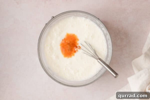 Crimson Snowcap Gelatin 6 Whisking sour cream and vanilla into the half-n-half jello mixture