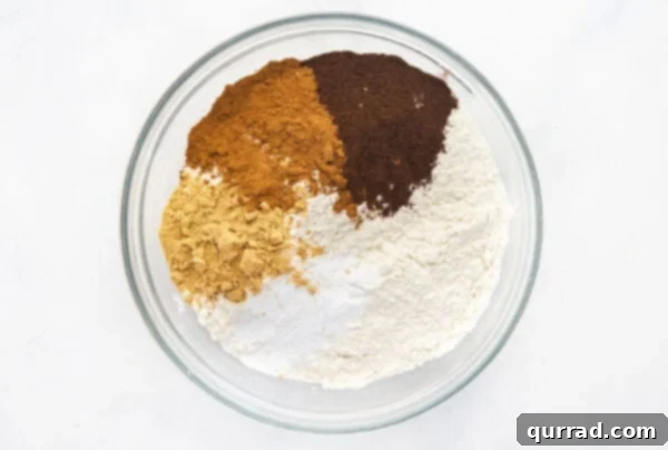 Flour and spices in a bowl, ready to be whisked for gingerbread cookies.