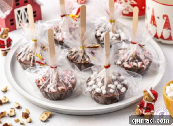 A plate of hot chocolate on a stick individually wrapped in cellophane.
