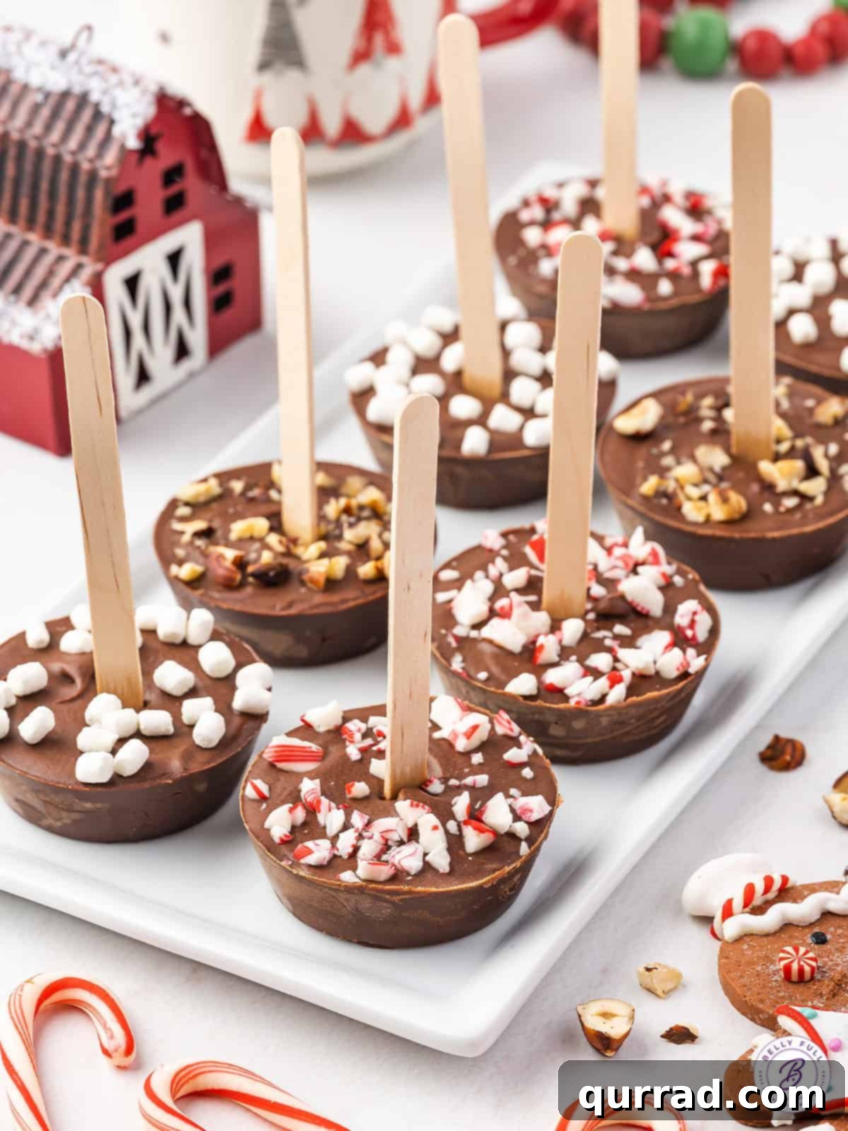 Hot chocolate sticks on a serving tray, garnished with various toppings.