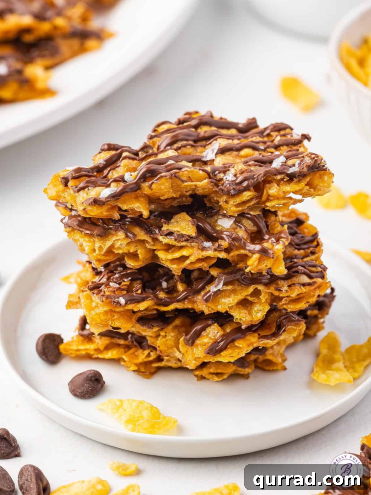 Crispy Cornflake Chocolate Bark 2 A stack of pieces of cornflake brittle, highlighting its golden caramel and chocolate drizzle