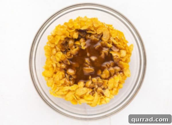 Crispy Cornflake Chocolate Bark 10 Hot caramel mixture being poured over cornflakes in a bowl