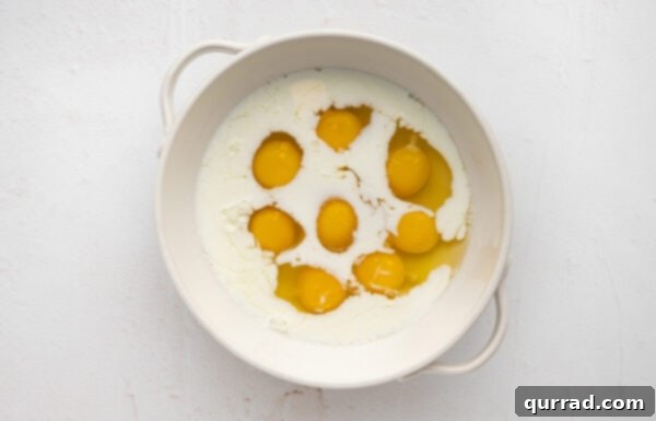 Whisked eggs and half-and-half in a bowl, ready for additions
