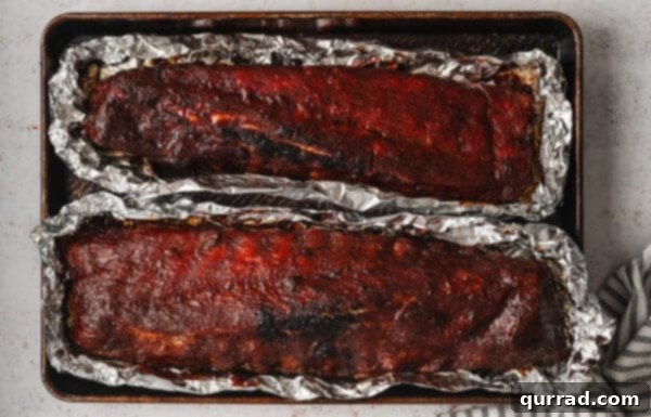 Fall-Off-The-Bone Baked Ribs 11 Overhead view of baked baby back ribs on foil