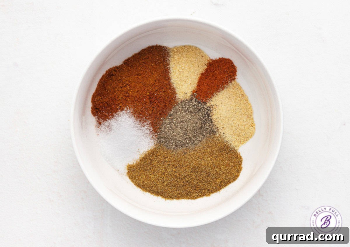 Individual chili seasoning ingredients laid out in small bowls, ready to be combined