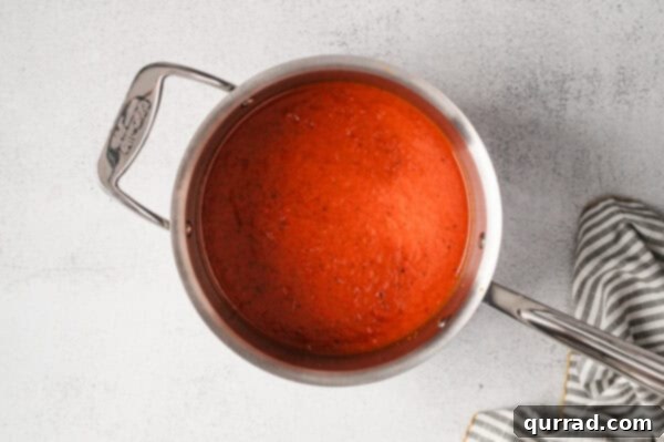 Roasted red pepper soup in a pot.