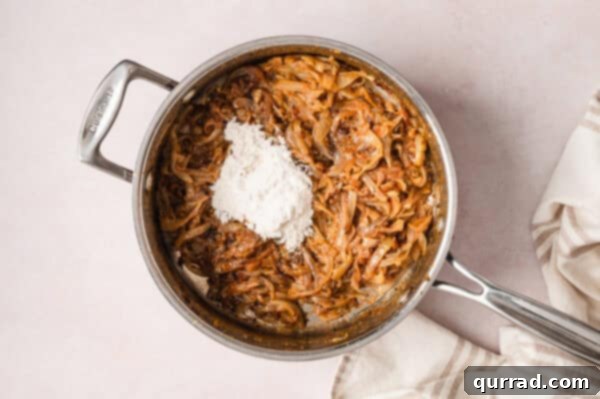 French Onion Macaroni Gratin 9 Flour added to caramelized onions in a pan.