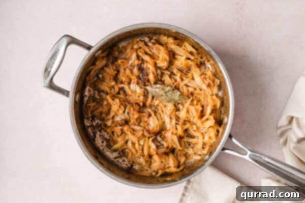 French Onion Macaroni Gratin 7 A bay leaf added to caramelized onions in a pan.