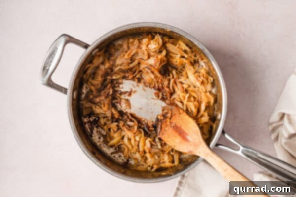 French Onion Macaroni Gratin 8 Balsamic vinegar added to caramelized onions in a pan.