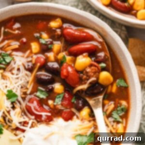 Seven Can Soup 5 A bowl of 7 can soup with shredded cheese, sour cream, and avocado slices