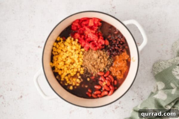 Beans, Rotel, corn, and seasonings in a pot, undrained.