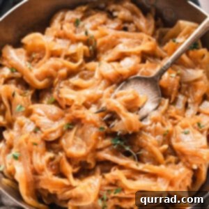 A spoon in a bowl of caramelized onions