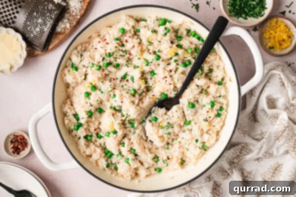 No-Stir Oven Risotto 9 An overhead view of a pot filled with rich, creamy baked risotto, garnished and ready to serve.