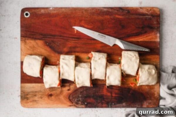 A log of pizza dough cut into eight pieces