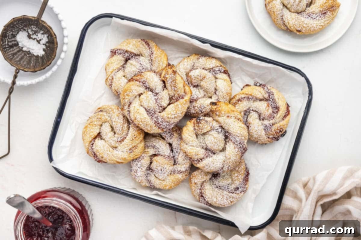 Puff Pastry Jam Spirals 10 Jam Puff Pastry Rolls piled on serving tray, dusted with powdered sugar