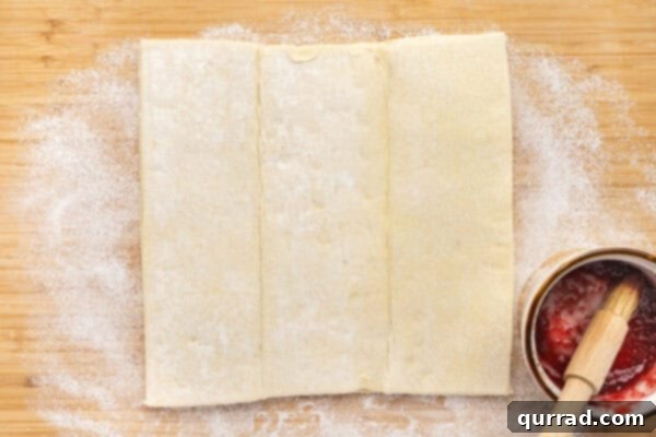 Puff Pastry Jam Spirals 4 A puff pastry sheet on a cutting board