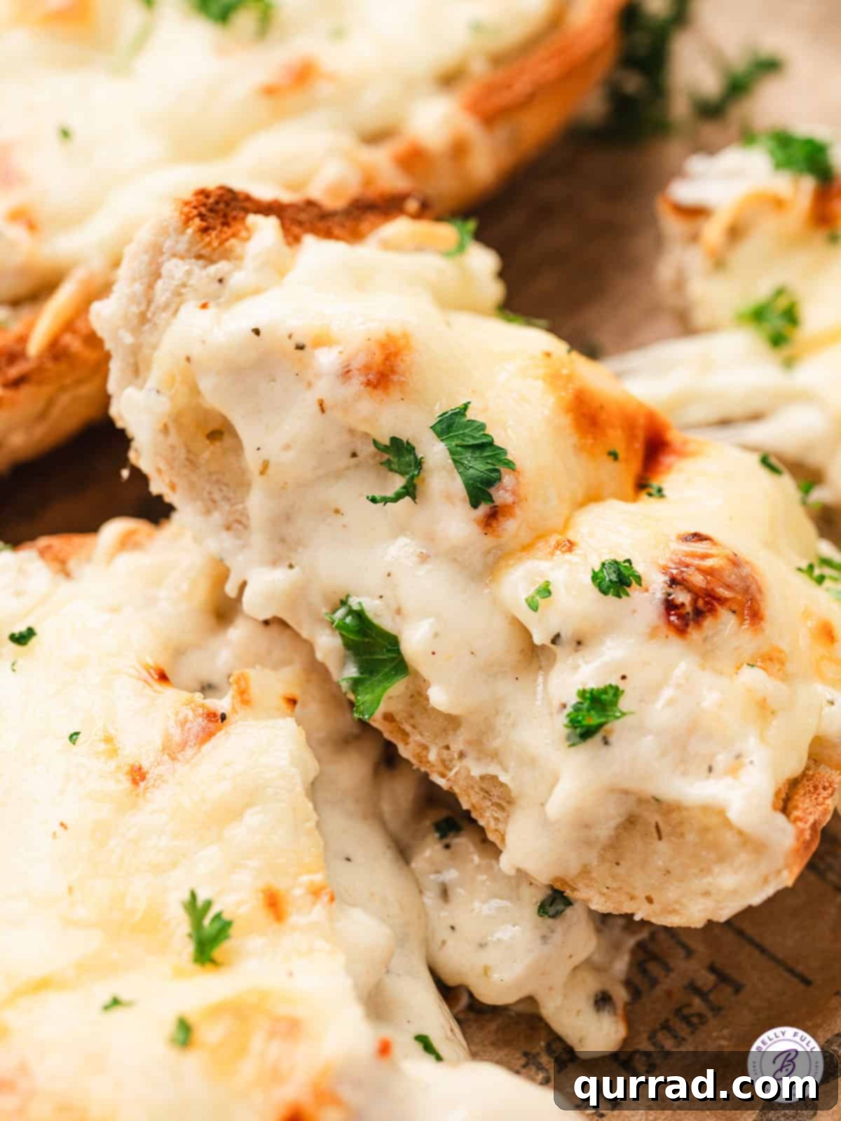 A mouthwatering close-up of cheesy Chicken Alfredo French Bread Pizza. Close up of a slice of chicken alfredo French bread pizza, showing melted cheese and tender chicken.