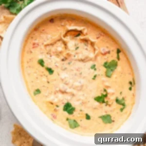 Overhead view of bubbling Rotel and sausage cheese dip in a crockpot