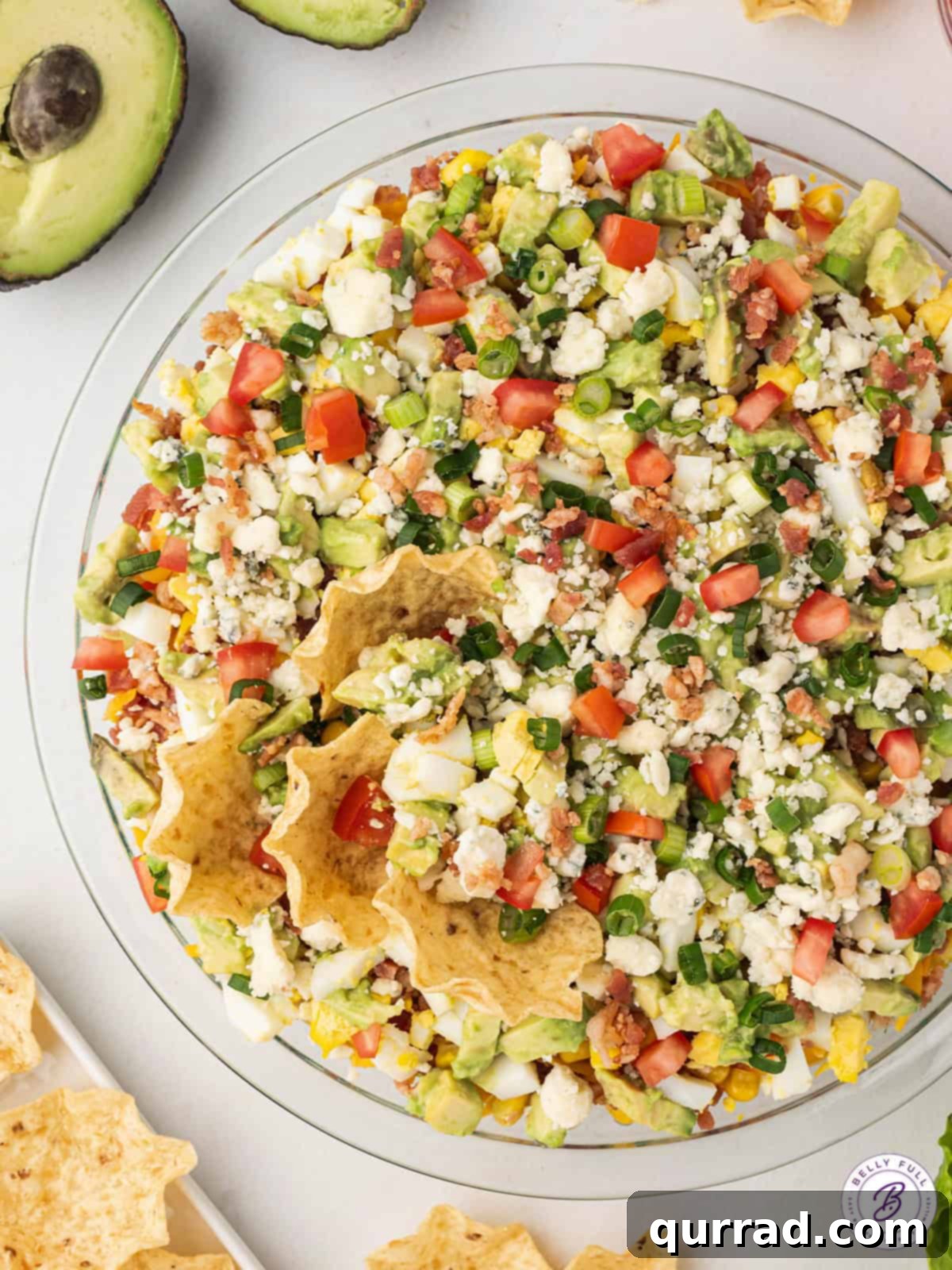 Cobb Salad Dip: The ultimate fresh and easy party appetizer. Overhead shot of the completed Cobb Salad Dip in a round dish, ready to be served as a delightful appetizer.