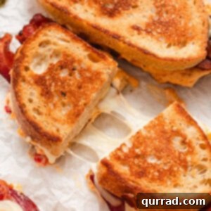 A pimento grilled cheese cut in half, showing the rich filling and golden crust.