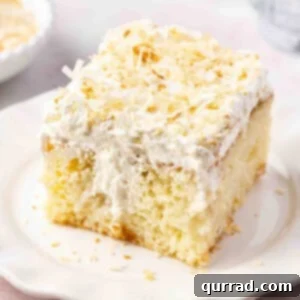 A smaller square image of a delicious slice of frosted coconut cake on a plate.