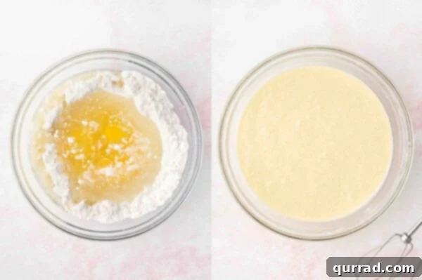 Light-colored batter for coconut cake being mixed in a large white mixing bowl, showing a smooth, creamy texture.
