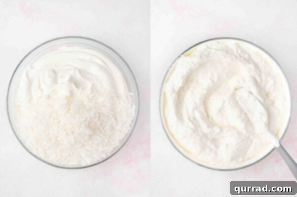 Fluffy white whipped topping mixed with sweetened coconut flakes in a clear glass mixing bowl.