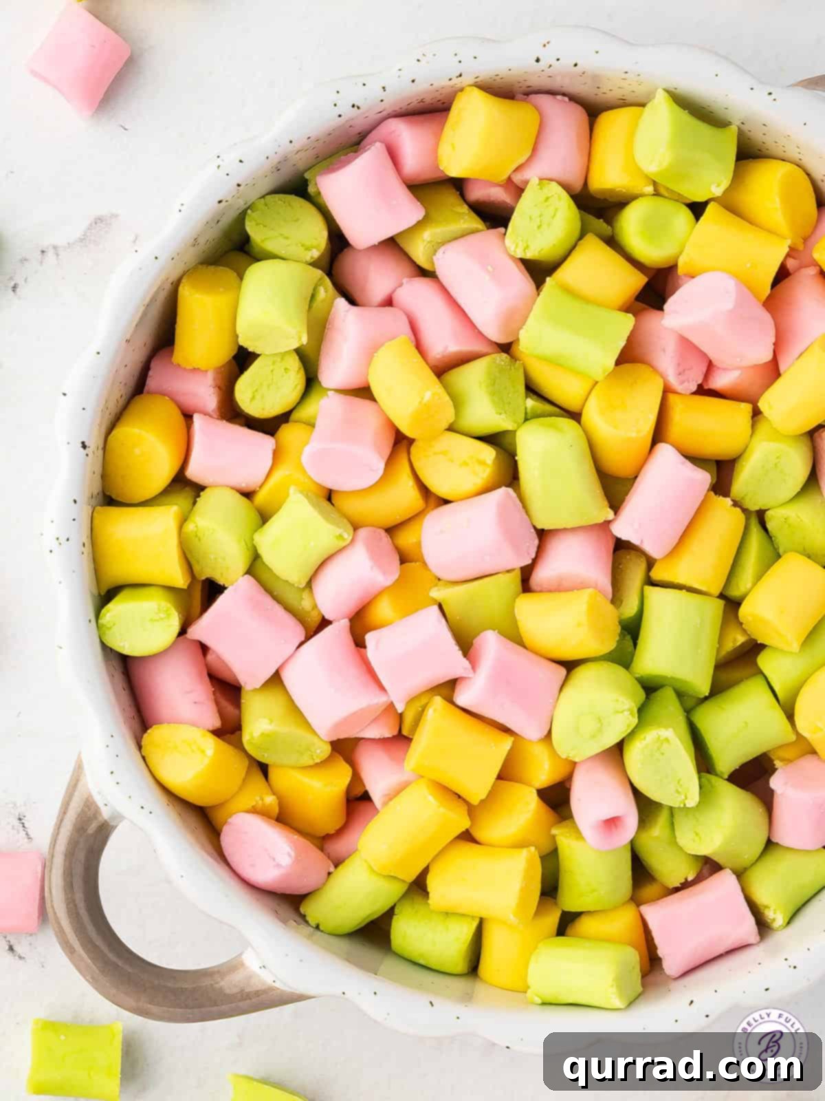 A beautifully arranged bowl of pastel butter mints, showcasing their smooth texture and inviting colors.