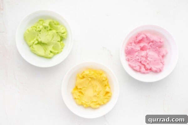 Three bowls of butter mint dough, each dyed a different pastel color