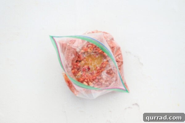 Strawberry Crunch Delight 5 crushed freeze dried strawberries, golden Oreos, and melted butter in a baggie