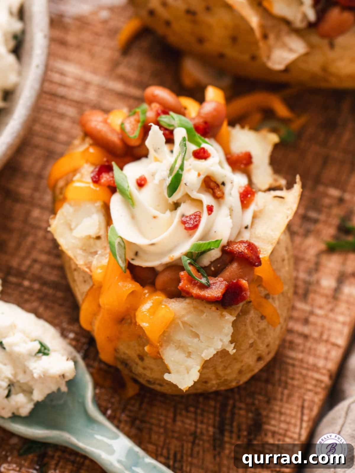 Loaded Baked Potato Delights 2 A stuffed jacket potato filled with whipped cream cheese, bacon, shredded cheddar, and scallions.