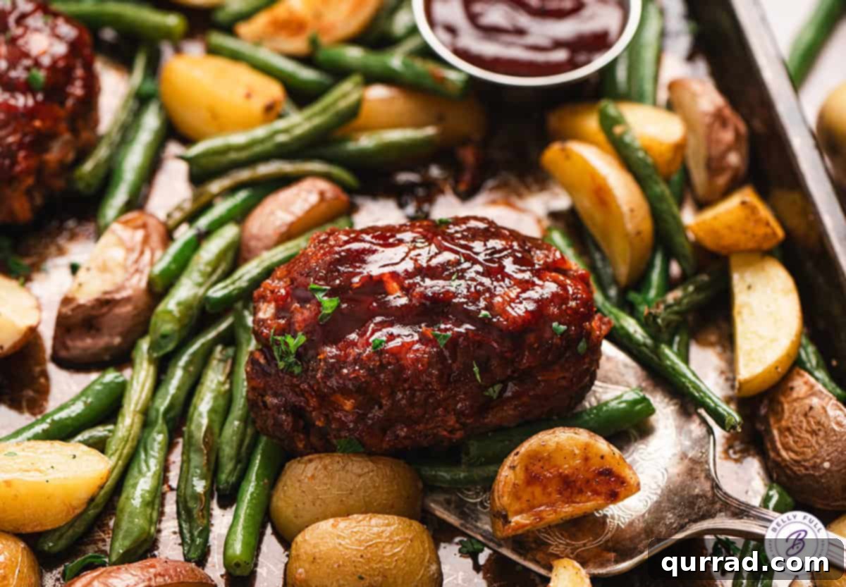 A family-friendly sheet pan dinner: Mini Meatloaves, Potatoes, and Green Beans Overhead view of sheet pan mini meatloaves with potatoes and green beans, ready to be served