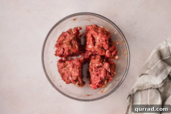 A bowl of ground beef mixture divided into four equal portions
