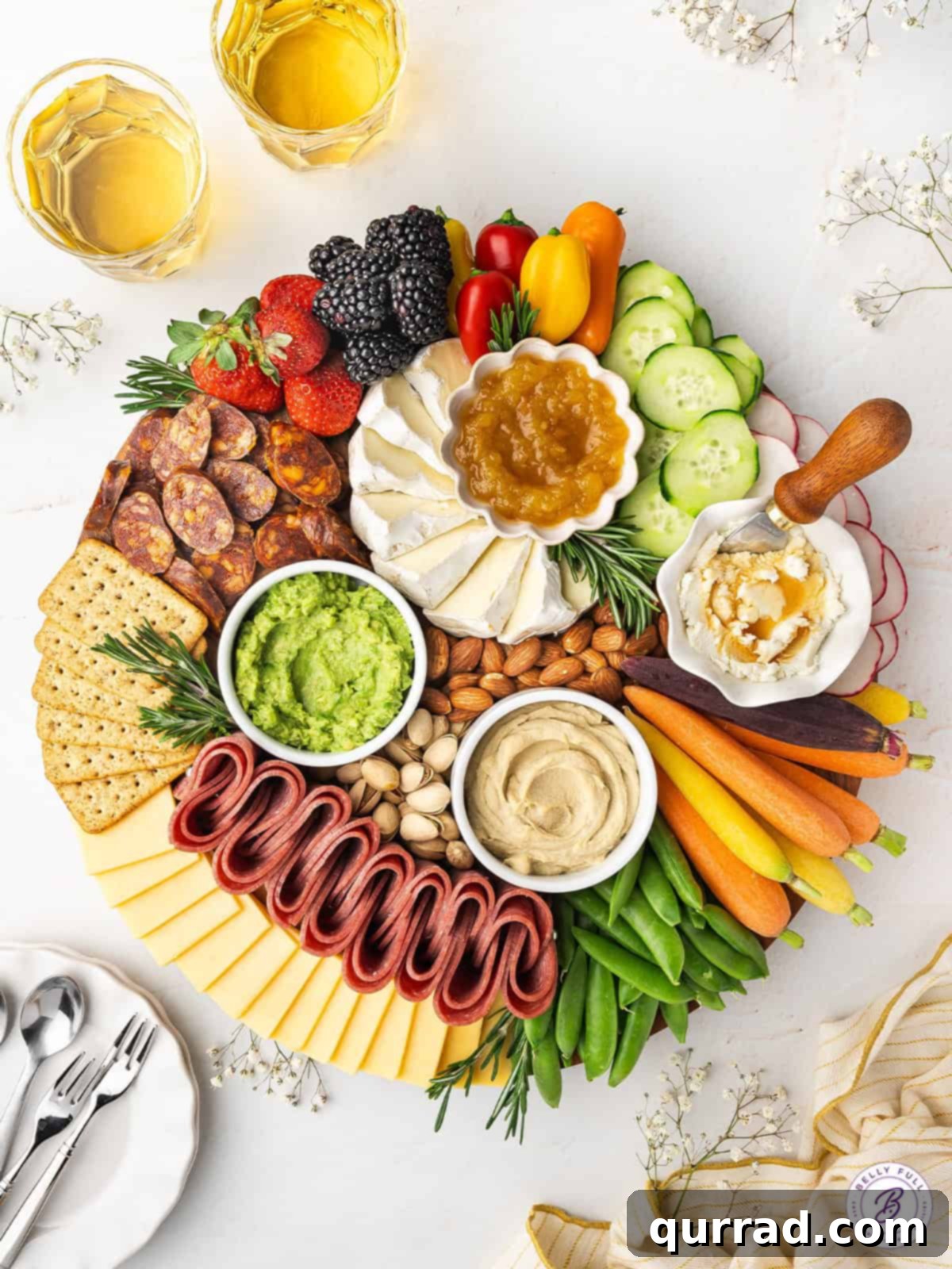 This Spring Charcuterie Board is loaded with spring produce, cheese, cured meats, nuts, and spreads. An easy appetizer for any gathering! An overhead view showcasing a vibrant and generously filled Spring Charcuterie Board, featuring fresh produce, a variety of cheeses, cured meats, nuts, and colorful spreads.