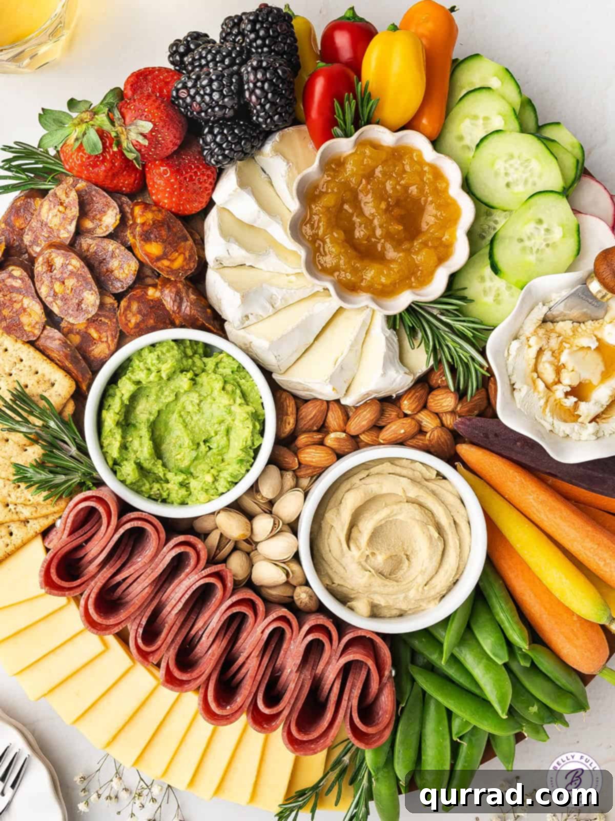 This Spring Charcuterie Board is loaded with spring produce, cheese, cured meats, nuts, and spreads. An easy appetizer for any gathering! A top-down view of the stunning Spring Charcuterie Board, showcasing its complete and colorful arrangement, ideal for gatherings and entertaining.