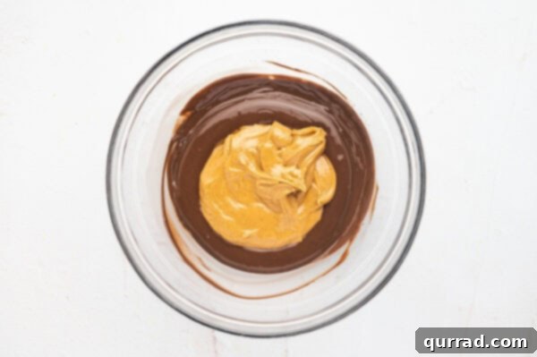 Peanut butter in a bowl with melted chocolate