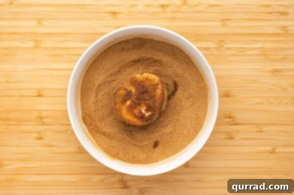 A marshmallow in a bowl of cinnamon sugar