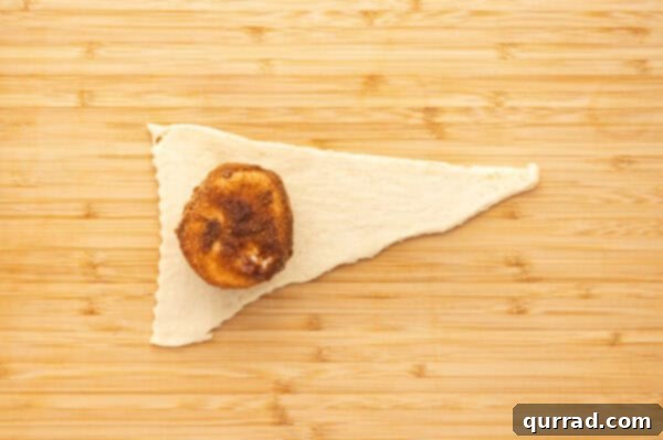 A cinnamon sugar marshmallow on a crescent dough triangle