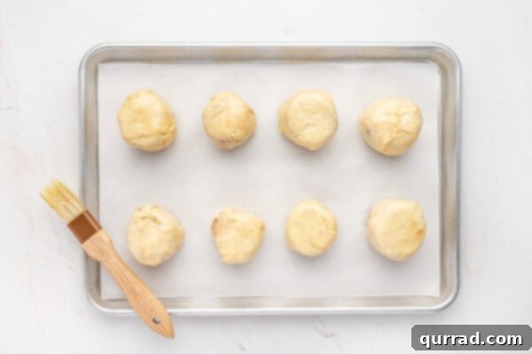 Unbaked resurrection rolls on a baking sheet
