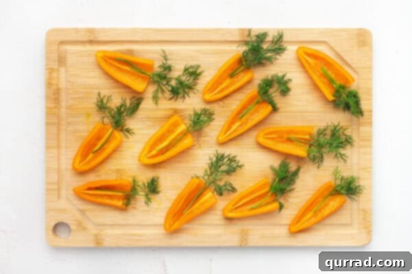 Carrot-Stuffed Bell Pepper Bites 4 Orange mini pepper halves topped with dill fonds