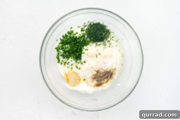 Carrot-Stuffed Bell Pepper Bites 5 Fresh herbs, seasonings, mayo, and cream cheese in a bowl