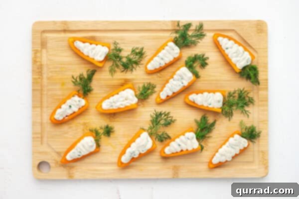 Carrot-Stuffed Bell Pepper Bites 6 Orange mini bell peppers stuffed with a cream cheese mixture on a cutting board