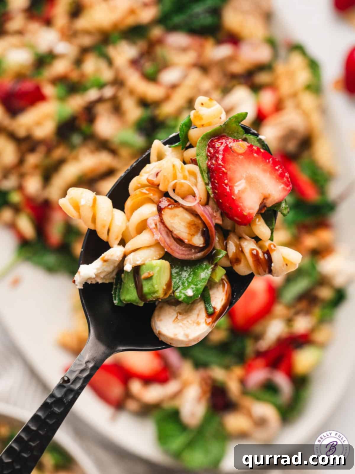 Strawberry balsamic pasta salad on a spoon