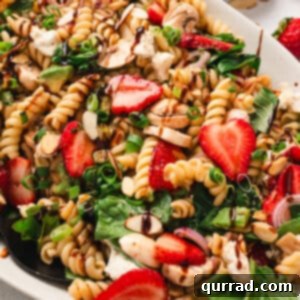 Overhead view of a platter of strawberry balsamic pasta salad