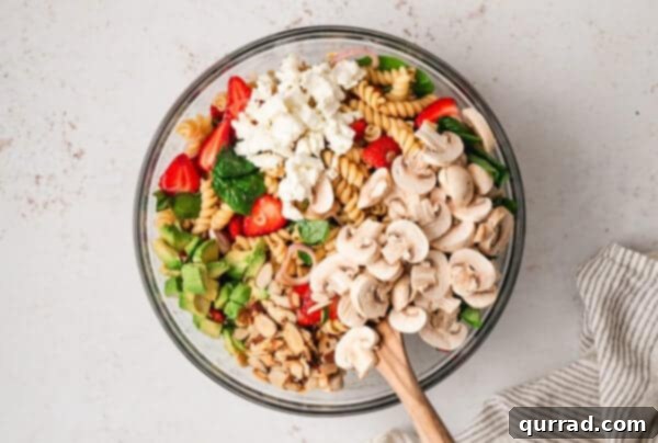 Strawberry balsamic pasta salad ingredients in a bowl