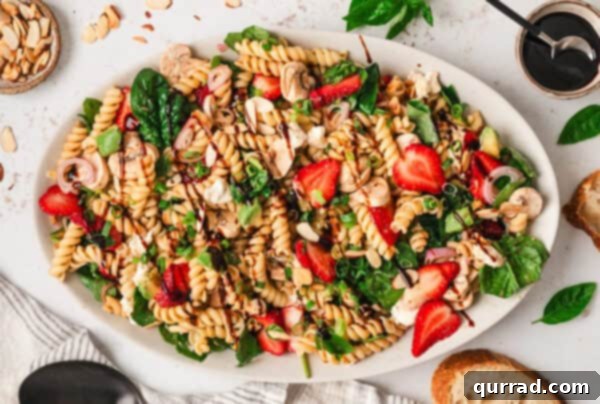 Overhead view of a plate of strawberry balsamic pasta salad