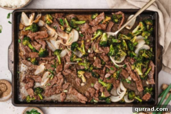 Effortless Sheet Pan Beef and Broccoli 7 Overhead view of finished sheet pan beef & broccoli, garnished and ready.