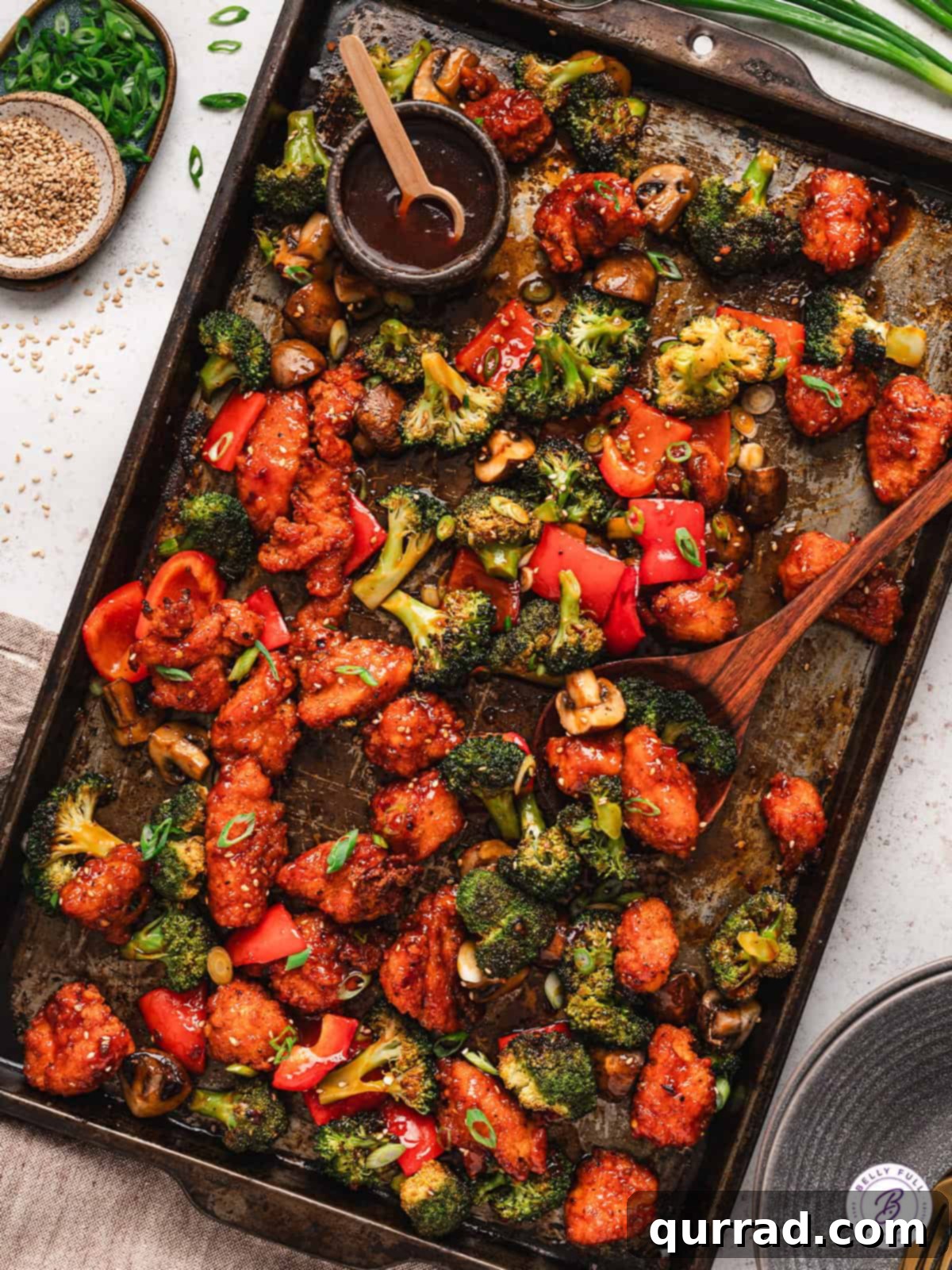 With pieces of breaded chicken, peppers, mushrooms, and broccoli, this Sheet Pan General Tso's Chicken makes a quick, easy dinner. Overhead view of sheet pan General Tso's chicken with rice