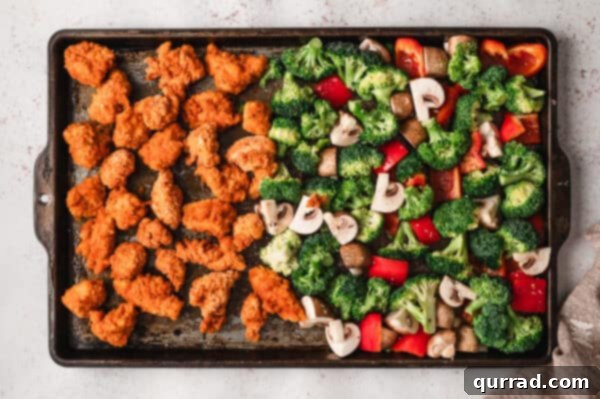 Crispy Oven Baked General Tso Chicken 3 Popcorn chicken and veggies on a sheet pan