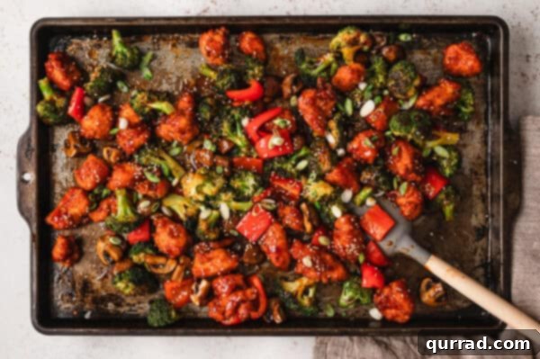 Crispy Oven Baked General Tso Chicken 5 Overhead view of sheet pan General Tso's chicken after saucing